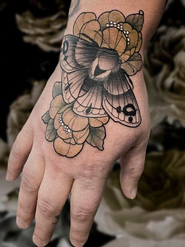 moth hand tattoo